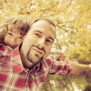 Happy father and child in autumn