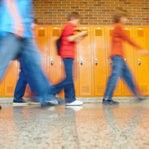 Full length of students walking in corridor