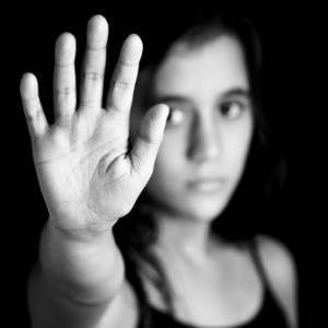 Girl with a hand signaling to stop in black and white