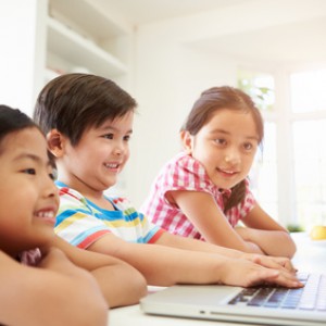 Three Asian Children Using Laptop At Home
